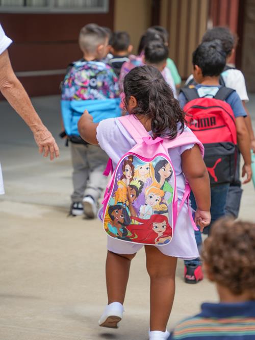 student walking into school with parent